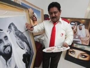 Dubai taxi driver adds finishing touches to portrait of the late Sheikh Zayed Bin Sultan Al Nahyan smiling at a falcon. (Photo courtesy: Gulf News)