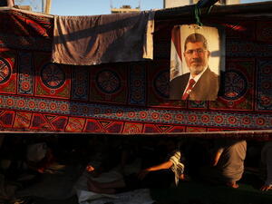 A picture of Mohamed Morsi hangs from a supporter's tent on July 10, 2013. (source: Getty / Spencer Platt) A picture of Mohamed Morsi hangs from a supporter's tent on July 10, 2013. (source: Getty / Spencer Platt)