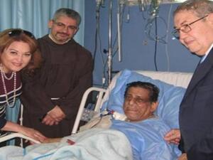 Farouk and his family by his bedside in hospital before he passed away. (Image: Facebook)