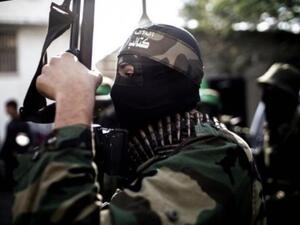 A Hamas member holds a gun during a march.