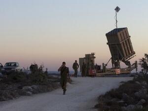 Israeli soldiers stand near an Iron Dome battery, a short-range missile defence system, designed to intercept and destroy incoming short-range rockets and artillery shells, near Jerusalem on Sunday. (AFP)