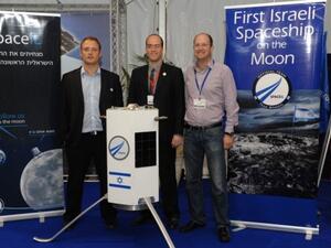 Three of SpaceIL's founders -- Yariv Bash, Yonatan Winetraub, and Kfir Damari -- with a model of the spacecraft they propose to send to the moon (photo: Times of Israel / Alon Hadar)