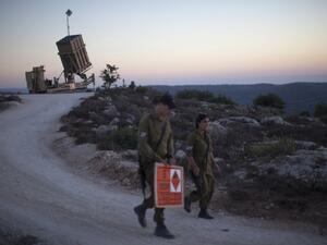Israeli soldiers walk by an "Iron Dome" battery, a short-range missile defence system in Jerusalem. An Israeli official said Thursday that he supports the Russian plan that seeks to destroy Syria's chemical weapons. (AFP)
