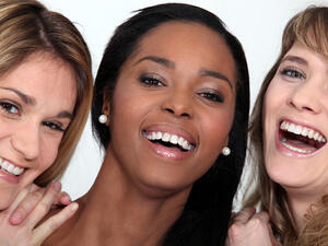 Three women are smiling. They must not be from Lebanon. 