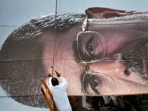 A supporter builds a giant portrait of deposed president Mohammad Morsi on July 25 in Cairo. (AFP / Fayez Nureldine)