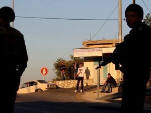 شبان فلسطينيون ينظرون الى جنود اسرائيليين في مستوطنة قرب نابلس 
