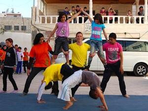 Mohammad, centre in the yellow tshirt, peforms at a Palestinian Circus School open day in Hebron in May 2012. Seven months later, he was killed by the Israeli army. (Photo courtesy of Palestinian Circus School/Your Middle East)
