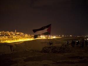 A Palestinian flag flutters at a protest camp in the controversial West Bank area known as E1 located east of Jerusalem and near the Jewish settlement of Maaleh Adumim early on Sunday. Hundreds of Israeli police dismantled the protest camp on the outskirts of Jerusalem overnight, activists and police said. (Photo: AFP / Ahmad Gharabli). 