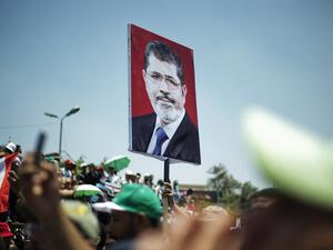 Egyptian Islamist groups led by the ruling Muslim Brotherhood shout slogans during a demonstration to mark the upcoming one year anniversary since President Mohamed Morsi (portrait) was elected, on June 21, 2013 in Cairo. (Source AFP/GIANLUIGI GUERCIA)