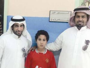 Bashar / Abdul Rahman with two of his teachers. (Photo: Al Sharq)