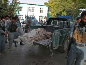 Afghanistan policemen stand near bodies of Taliban fighters, as they lie on a police vehicle in the grounds of the main hospital in Ghazni on September 1, 2013. (AFP)