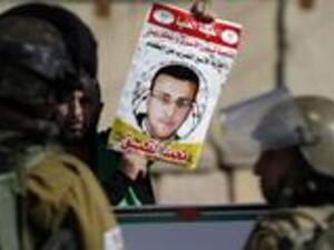Mohammed al-Qiq, an imprisoned Palestinian journalist who has been on hunger strike for 72 days, says he has rejected Israel's decision to temporarily suspend his administrative detention. (AFP/File)