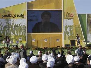 Hezbollah Commander Nasrallah speaks on screen in Beqaa, Lebanon (AFP / File)