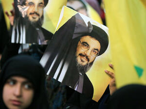 Hezbollah supporters carry posters of chief Sayyed Hassan Nasrallah at a rally. (AFP/File)