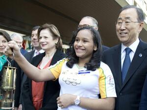 UN chief Ban Ki-moon watches as Bruna Gabriella holds the 2016 Olympic flame during a ceremony at the UN offices in Geneva, on April 29, 2016. (UN/AFP)