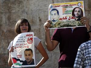Palestinian protestors hold posters of Bilal Kayed, protesting his administrative detentio at Damascus Gate, a main entrance to Jerusalem's Old City. (AFP/Ahmad Gharabli)