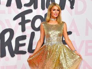 Paris Hilton wowed in a gold sleeveless gown on Sunday night at the Cannes Fashion For Relief gala (Source: YANN COATSALIOU / AFP) 
