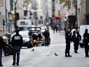 Police stand near Cafe La Belle Equipe, one of the sites of the Paris attacks. (AFP/Loic Venance)