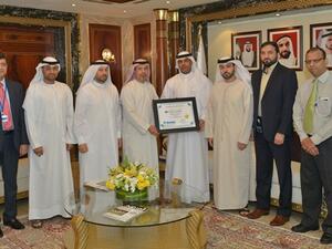 Ahmed Mahboob Musabih and Juma Al Ghaith in a group photo with the project team