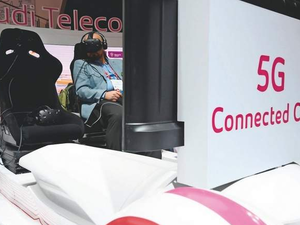 A man tries the Saudi Telecom virtual reality glasses on a 5G connected car at the MWC 2018 in Barcelona. (AFP)