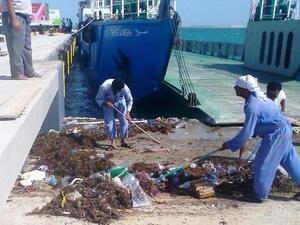 ADPC workers in action cleaning the Mugharrag Port in the Western Region
