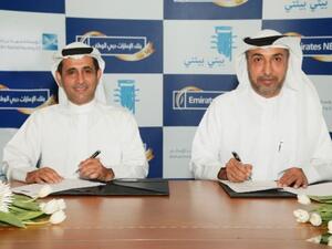 Al Marzouqi with Al Marri at the signing ceremony