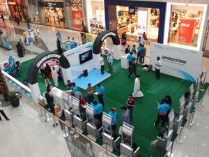 Mall goers learning about proper tyre care and maintenance at the Bridgestone ‘Tyre Safety and Eco Station’ at the Bahrain City Centre in Manama