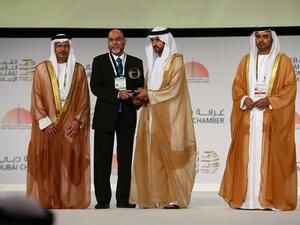 CEO of Dar Al Sharia receiving the award