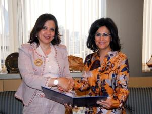 KALD Chairwomen Amal Al Sayer receives the sponsorship check from NBK CEO Shaikha Al Bahar