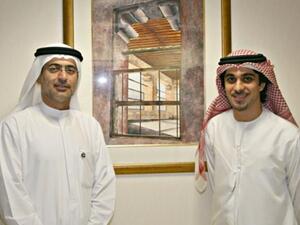 Mohammed Sharaf, CEO, DP World, and Farid Mohammed Al Rais, with the Auctioned Painting