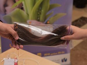 13 female employees donated locks of hair which will be used to make artificial hair for cancer patients.