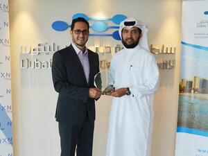 Engineer Muammar Al Katheeri and Ghazi Atallah carrying the award.