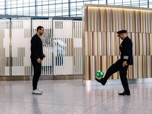 Former England international and Manchester United legend Rio Ferdinand (L) showing off some of his football skills.
