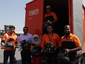 TNT Team Members distribute food packs to Seafarers in Sharjah.
