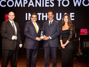 UAE Exchange CEO Promoth Manghat (left) and UAE Exchange President Y Sudhir Kumar Shetty (right) recieving the Great Place to Work Award