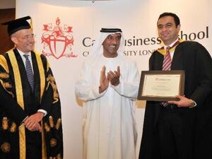 Sheikh Ahmed bin Saeed Al Maktoum and Professor Paul Curran delivering the Cass Executive MBA degree to a student