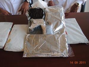 The two smugglers with the seized drugs