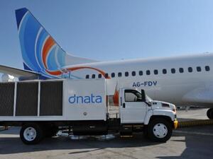 flydubai aircraft with dnata air conditioning unit truck