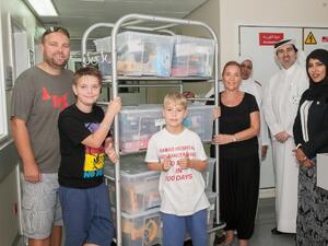 Fundraiser Finn Froud with toy packages for child cancer patients at Hamad General Hospital