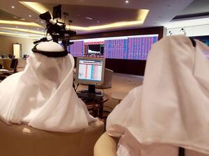 Traders monitor screens displaying stock information at Qatar Stock Exchange in Doha on June 5, 2017. (Reuters)