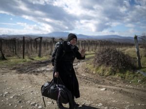 A migrant woman crosses the Greek-Macedonian border near the town of Gevgelija, on February 14, 2016. (AFP/Robert Atanasovski)