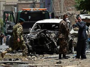 Afghan security forces inspect a damaged vehicle at the site of a bombing in the capital. (AFP/File)