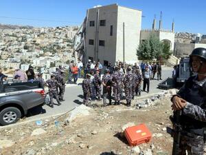 Jordanian security forces gather near a damaged building in the city of Salt, northwest of the capital Amman, on August 12, 2018. AFP
