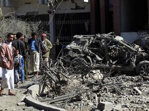 Yemeni men inspect damaged vehicles following an air-strike by the Saudi-led coalition in the capital Sanaa, on February 27, 2016. (AFP/Mohammed Huwais)