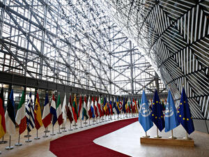 Flags of UN and EU stand in European council Building (Shutterstock)