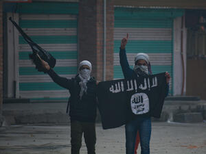 Kashmiri masked protester waving flags during clashes in Nowhattah Srinagar after Friday prayers on 21st December 2018. (Shutterstock/ File Photo)