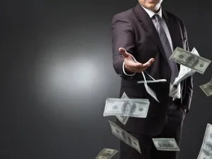 The video showed one person throwing Dh1,000 bank notes under his feet while being encouraged by the second. (Shutterstock)