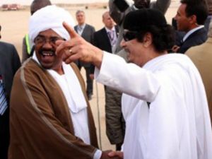 القذافي مستقبلا البشير خلال زيارة سابقة