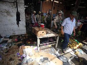 Iraqi security forces gather at the site of a suicide bombing in northern Baghdad on May 17, 2016. (AFP/Ahmad Al-Rubaye)