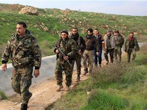Syrian soldiers and local pro-government fighters patrol the Handarat region, located in northwestern Syria. (AFP/File)